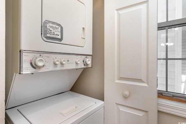 clothes washing area with stacked washer and dryer