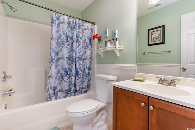 full bathroom featuring a textured ceiling, tile floors, shower / bath combination with curtain, large vanity, and toilet