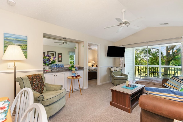 carpeted living room featuring ceiling fan and lofted ceiling