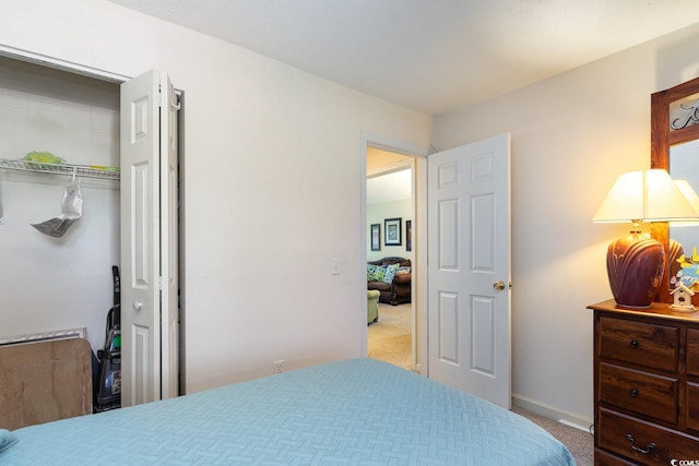 bedroom featuring a closet and light colored carpet