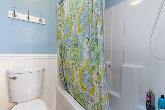 bathroom with toilet and shower / tub combo with curtain