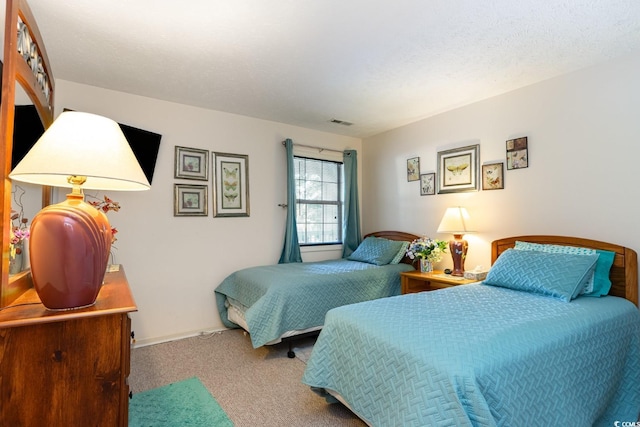 carpeted bedroom with a textured ceiling