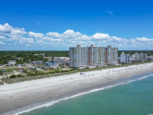 drone / aerial view featuring a beach view and a water view