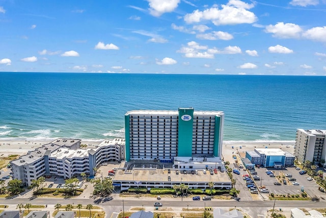 drone / aerial view featuring a beach view and a water view