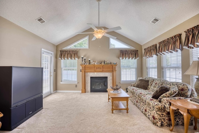 carpeted living room with a textured ceiling, ceiling fan, and lofted ceiling