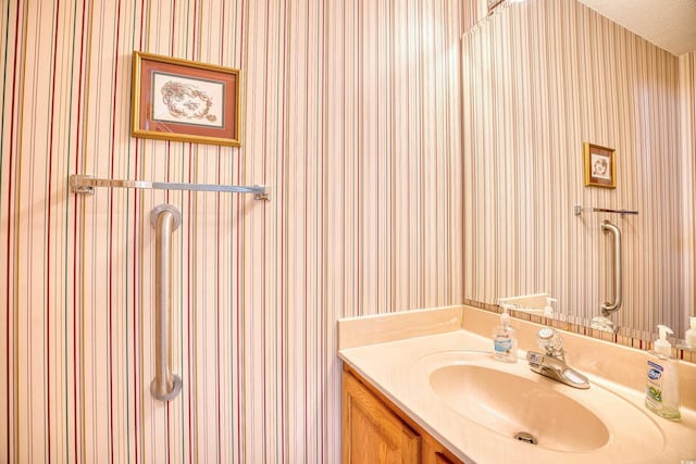 bathroom with vanity and a textured ceiling