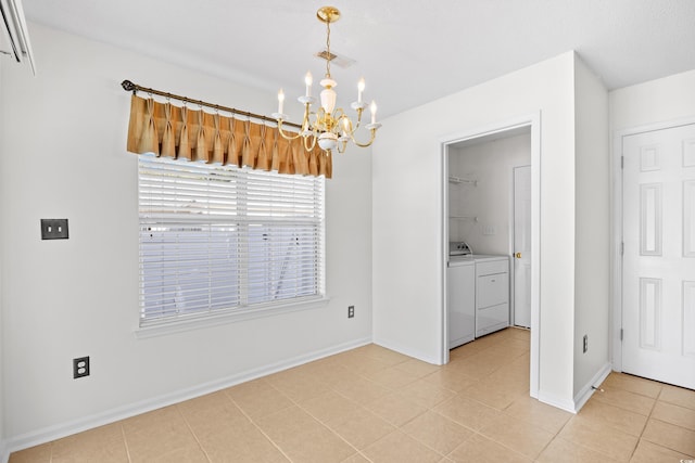 unfurnished dining area featuring a chandelier, independent washer and dryer, light tile patterned floors, and baseboards