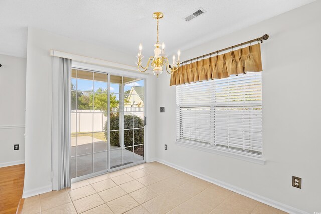 2513 Hunters Trl, Myrtle Beach, SC 29588 - unfurnished dining area featuring a chandelier, baseboards, and tile patterned flooring