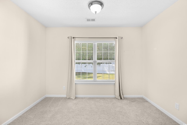 empty room with plenty of natural light, carpet flooring, and baseboards