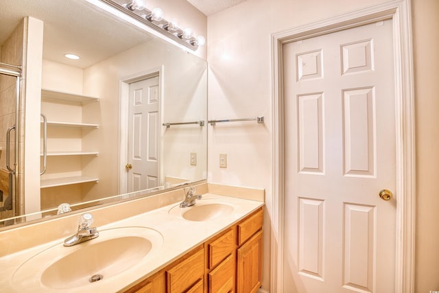 bathroom with vanity and a textured ceiling