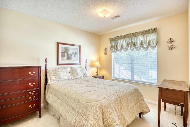 carpeted bedroom with a textured ceiling