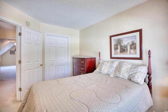 carpeted bedroom with a closet and a textured ceiling