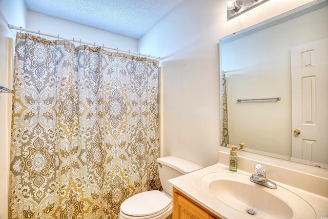 bathroom featuring vanity, a shower with shower curtain, a textured ceiling, and toilet