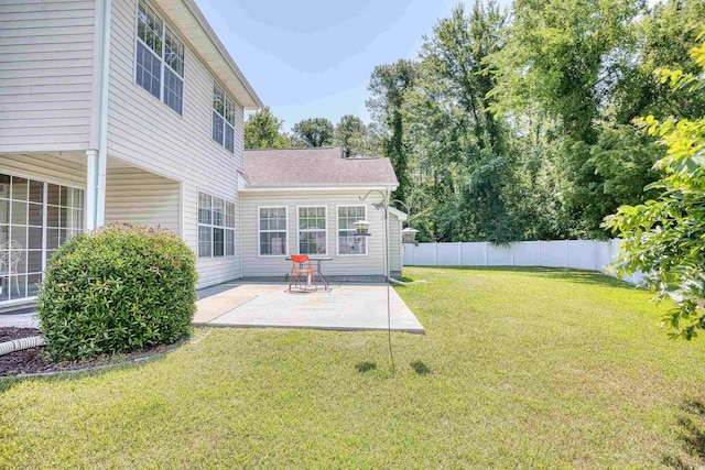 back of property with a patio and roof with shingles
