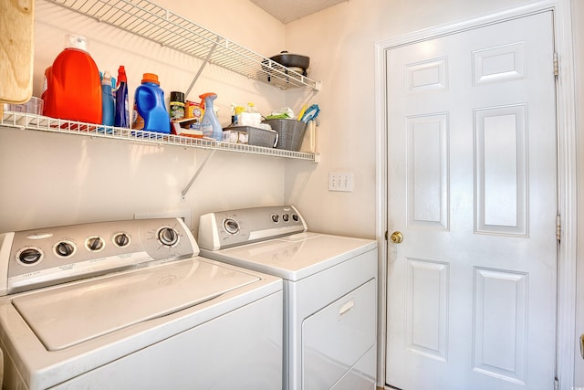 clothes washing area featuring washer and clothes dryer