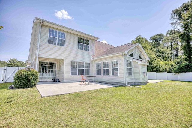 rear view of house featuring a patio area and a yard