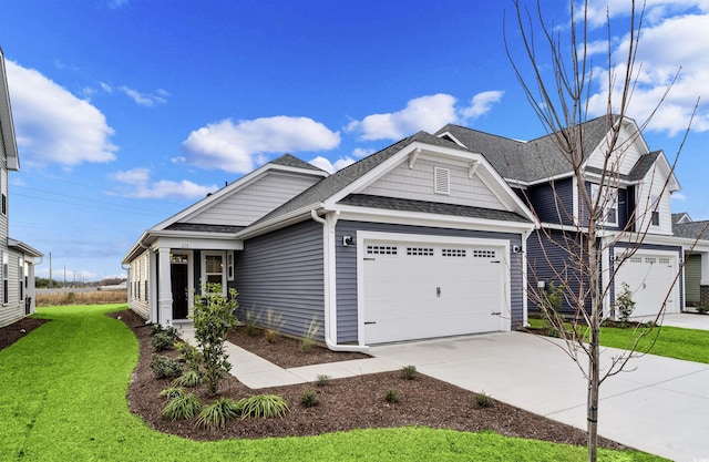 view of front facade with a garage and a front lawn