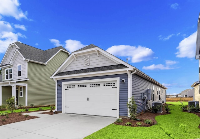 craftsman inspired home featuring central AC, a front yard, and a garage