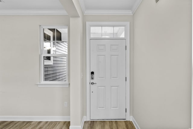 foyer entrance featuring wood-type flooring and crown molding