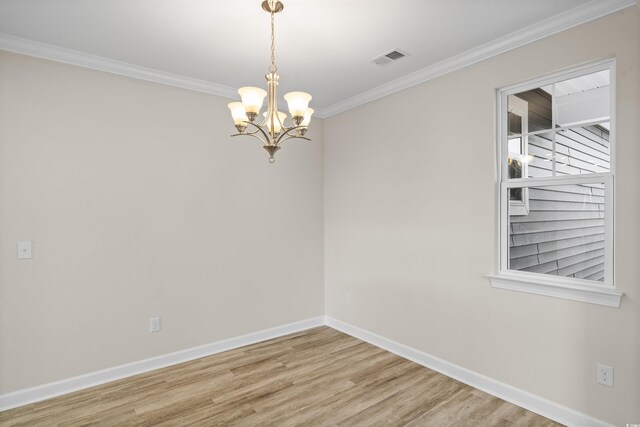 unfurnished room featuring ornamental molding, a chandelier, and wood-type flooring