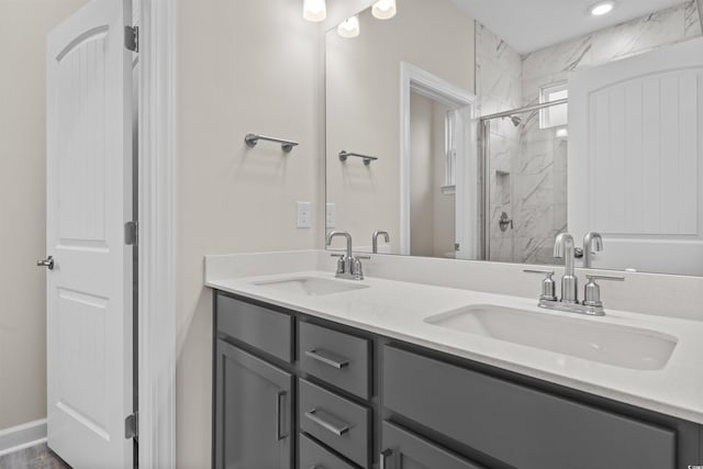 bathroom with vanity and a shower with door