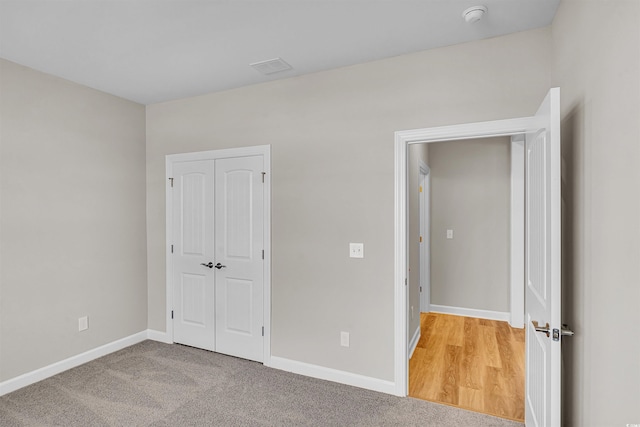 unfurnished bedroom with carpet flooring and a closet