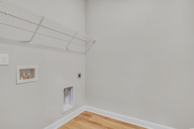 washroom featuring electric dryer hookup, hookup for a washing machine, and hardwood / wood-style flooring