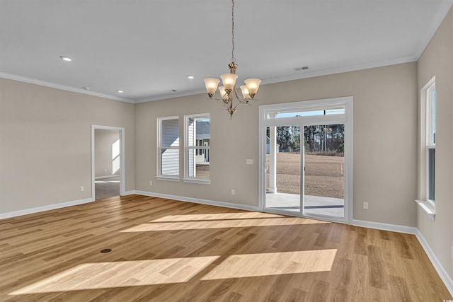 interior space featuring crown molding, plenty of natural light, and a notable chandelier