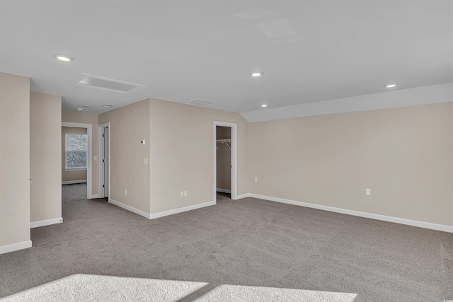 carpeted spare room with lofted ceiling