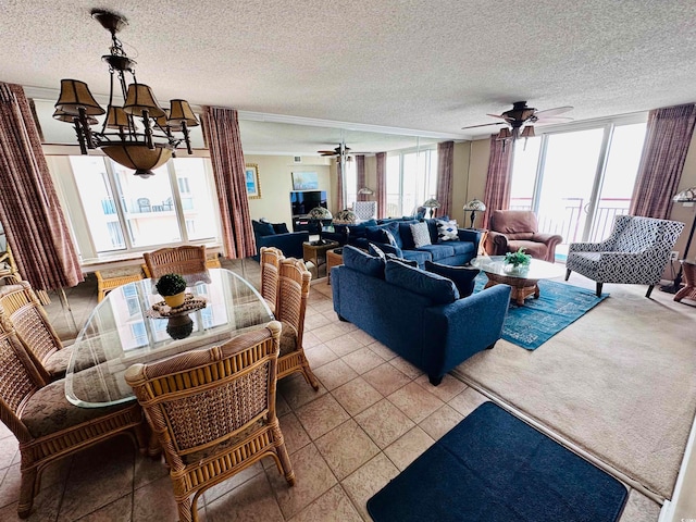 tiled dining room featuring ceiling fan, a healthy amount of sunlight, and a textured ceiling