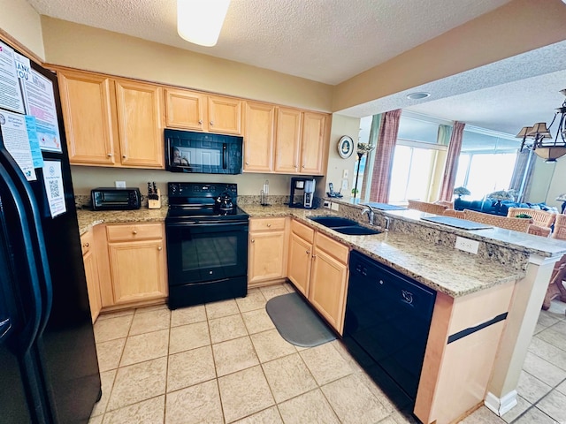 kitchen featuring sink, black appliances, light tile flooring, and kitchen peninsula