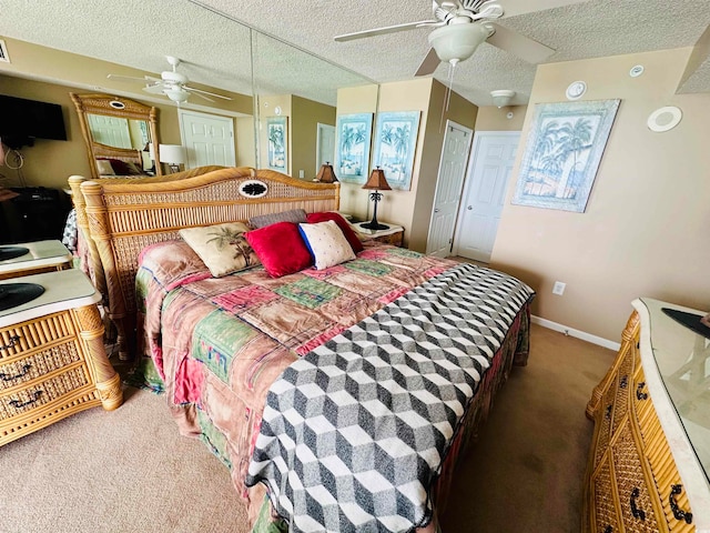 bedroom featuring ceiling fan, a textured ceiling, and carpet flooring