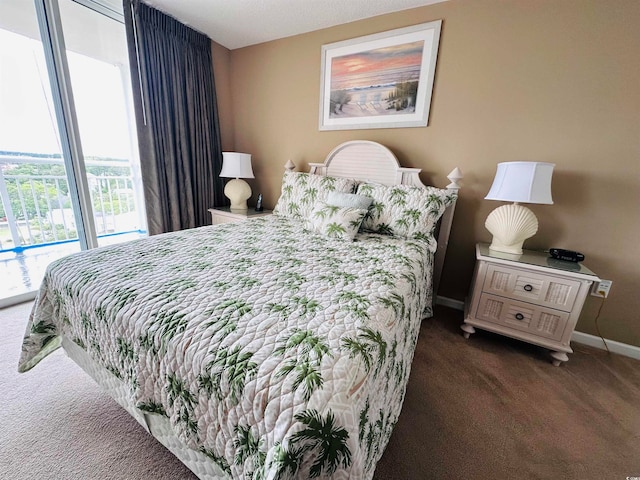 bedroom featuring dark carpet and access to outside