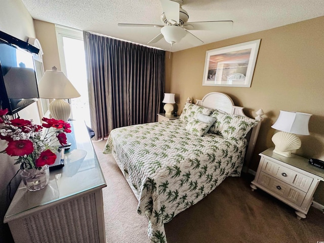 bedroom featuring ceiling fan, a textured ceiling, and carpet flooring