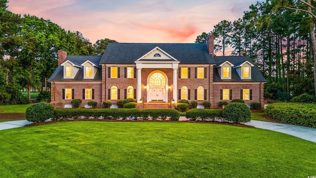 neoclassical / greek revival house featuring a lawn