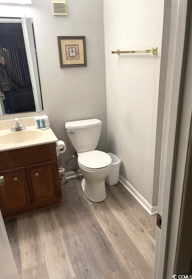 bathroom featuring hardwood / wood-style floors, toilet, and vanity