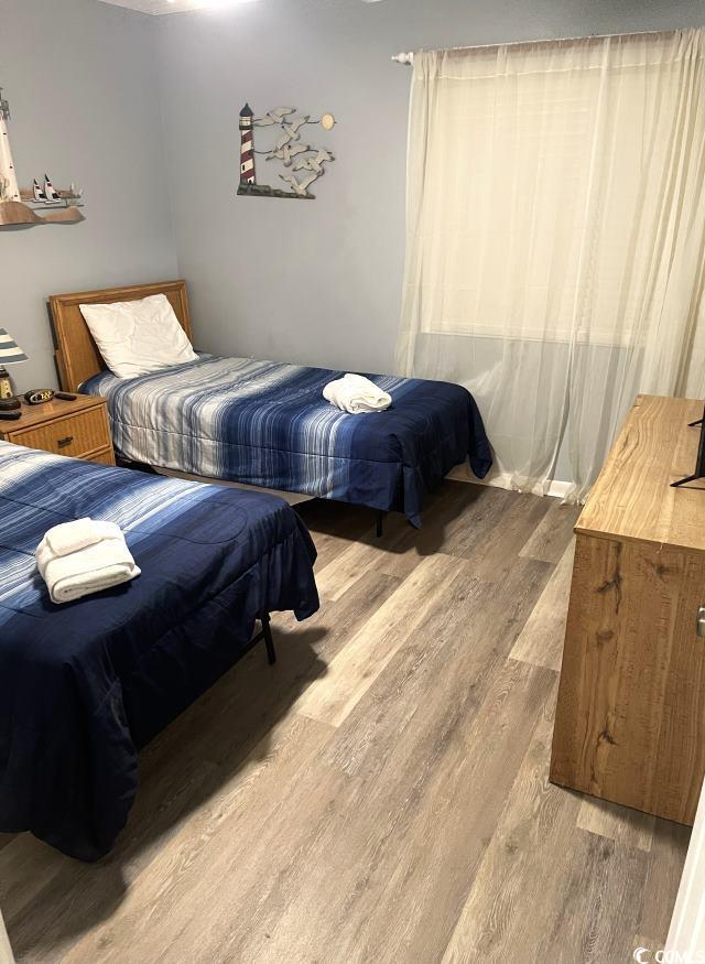 bedroom with wood-type flooring