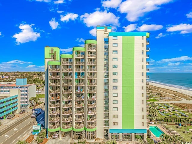 view of building exterior with a view of the beach and a water view