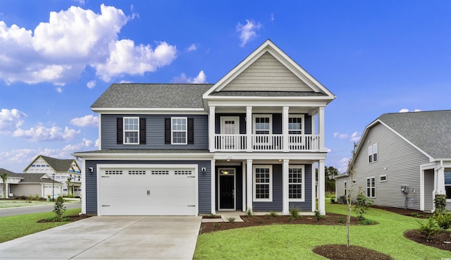 view of front of house with a balcony, a garage, and a front lawn