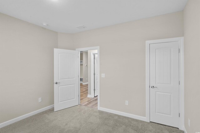 unfurnished bedroom featuring light carpet