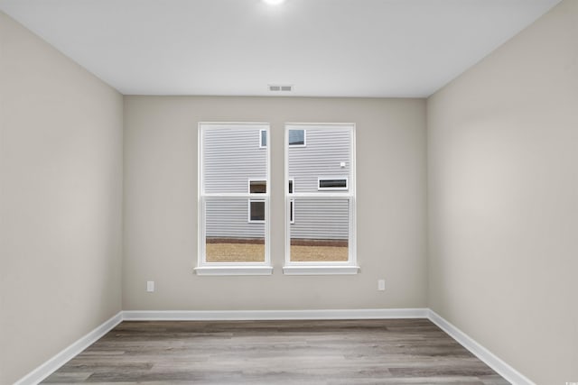 empty room with light hardwood / wood-style flooring