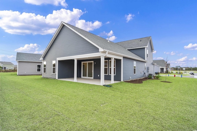 back of house featuring a patio area and a lawn