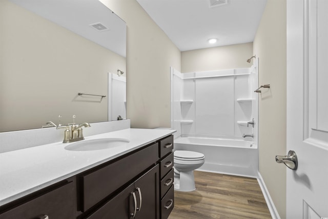 full bathroom with shower / bathing tub combination, toilet, vanity, and hardwood / wood-style flooring