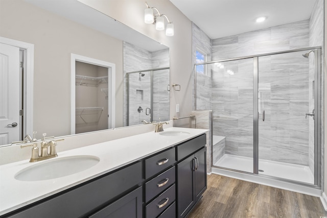 bathroom featuring wood-type flooring, vanity, and an enclosed shower