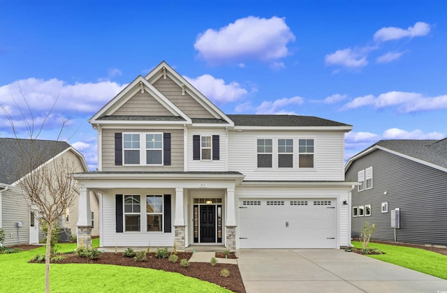 craftsman inspired home featuring a garage and a front lawn