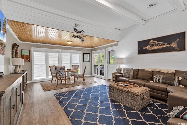 living room with crown molding and wood-type flooring