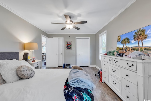 bedroom featuring ceiling fan, light hardwood / wood-style flooring, and ornamental molding