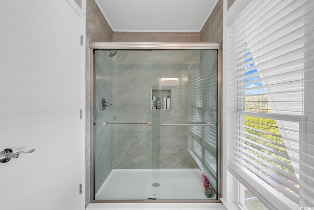 bathroom featuring a shower with door