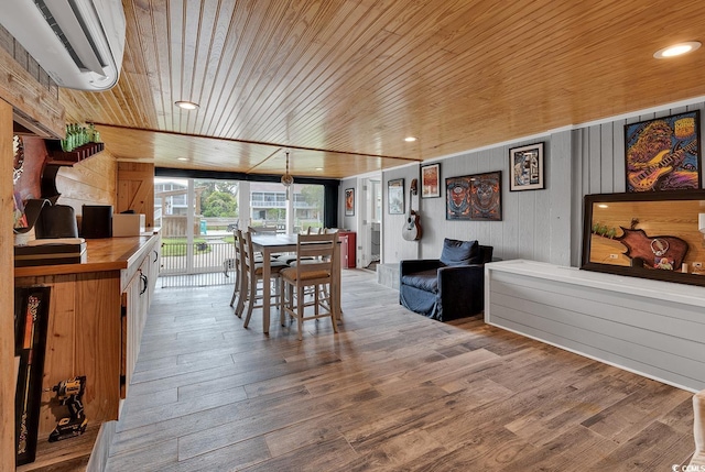 dining space featuring a wall mounted air conditioner, hardwood / wood-style floors, and wooden ceiling