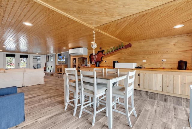 dining area featuring light hardwood / wood-style flooring, wood walls, wood ceiling, a wall unit AC, and french doors